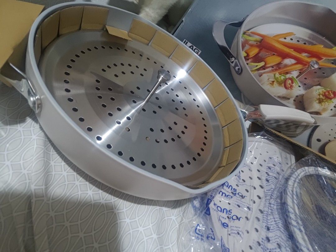 Tramontina All-in-One Plus Pan (Category: Cookware & Accessories) located in Manila. Submitted by ayasellss85933 (Listing ID 1438832506, Image 2). Description: - Tramontina All-in-One Plus Pan set. - Includes (1) 5Qt 4.7L Ceramic pan, (1) Stainless steel steamer insert, (1) Foldable silicone splatter screen, and (1) Glass lid with silicone rim. - Versatile for various cooking methods. - Ideal for steaming, boiling, and more. - Complete set with a