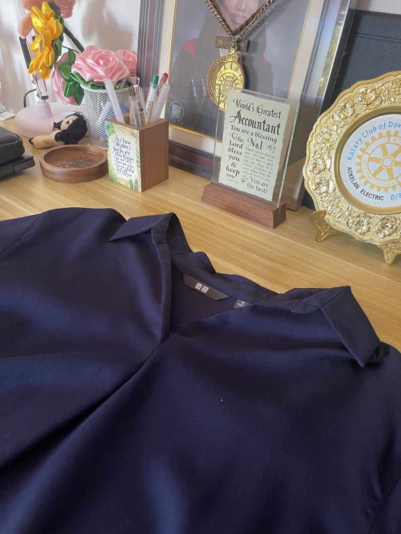 Uniqlo Navy Blouse - Size M (Category: Blouses) located in Manila. Submitted by abby_0101 (Listing ID 1438713531, Image 2). Description: - Uniqlo navy blue blouse - Size: M - Features a collared neckline - Relaxed fit - Versatile for casual and office wear - Simple and elegant design - Made of smooth, lightweight fabric.