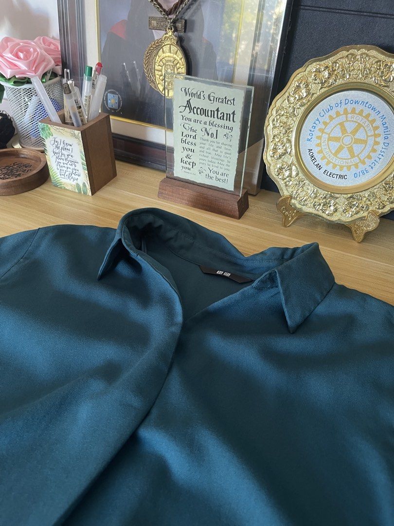 Uniqlo Teal Blouse - Size S (Category: Blouses) located in Manila. Submitted by abby_0101 (Listing ID 1438713436, Image 3). Description: - SUPER GOOD AS NEW - Uniqlo teal blouse - Size: S - Features a classic collar - Flattering silhouette - Suitable for casual and formal wear - Made from a smooth, lightweight fabric - A versatile wardrobe staple.