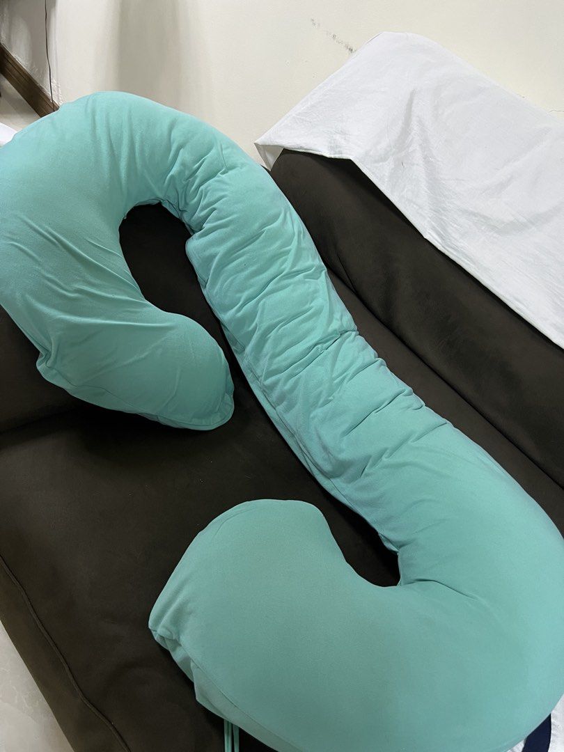 U-Shaped Pregnancy Pillow (Category: Bedding & Towels) located in Manila. Submitted by decluttermnlmd (Listing ID 1438787686, Image 1). Description: - U-shaped pregnancy pillow for full body support. - Light teal color. - Made of soft, stretchy fabric. - Supports back, hips, knees, neck, and head. - Ideal for side sleepers. - Provides all-night comfort..