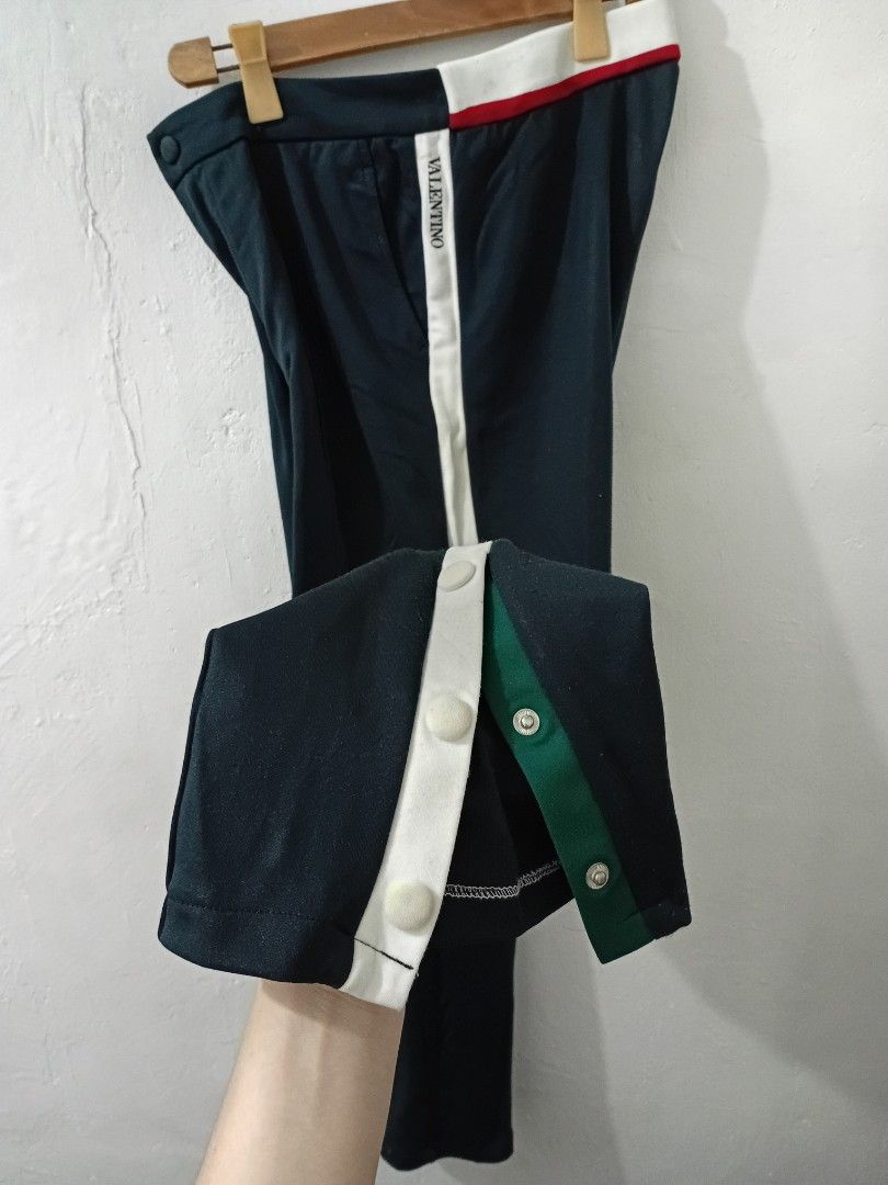 VALENTINO Sweat Trouser Track Pants (Category: Luxury Apparel) located in Navotas City. Submitted by ms.soulana (Listing ID 1438835030, Image 2). Description: PreOwned Lightly Used Authentic Valentino track pants - Color: Navy blue - Size: 48 Waist 32-34" X L39" - Made in Italy - White stripes on sides - Button details on legs - Red and white stripe detail on waistband Sign of Wear Good Condition 8.9/10 .