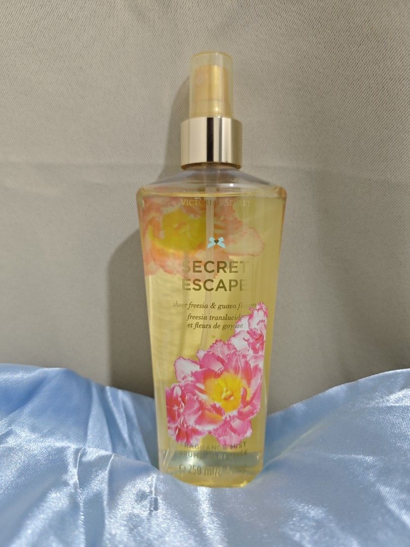 Victoria's Secret Secret Escape Body Mist (Category: Fragrance & Deodorants) located in Paranaque City. Submitted by laraceltura (Listing ID 1438763128, Image 1). Description: - Victoria's Secret Secret Escape body mist - Scent: Freesia and guava - Design: Floral with pink flowers - Bottle: Yellow-tinted liquid - Nozzle: Gold-colored.