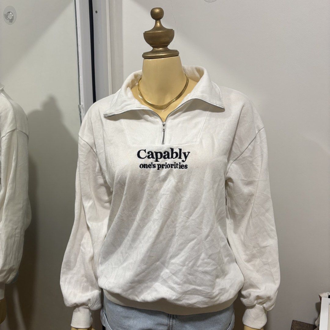 White Zip-Up Sweatshirt with Embroidery (Category: Coats, Jackets and Outerwear) located in Subic. Submitted by ysbllrs (Listing ID 1438877640, Image 1). Description: - White zip-up sweatshirt - Features "Capably" and "one's priorities" embroidery - Long sleeves - Relaxed fit - Soft, comfortable fabric - Perfect for casual wear.