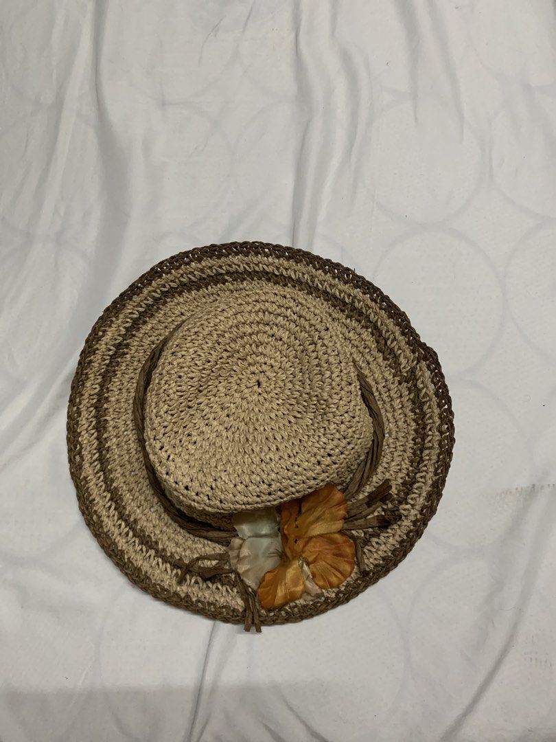 Woven Straw Hat with Flower for Summer and Beach (Category: Hats & Beanies) located in Quezon City. Submitted by thriftythought (Listing ID 1438794892, Image 3). Description: - Woven straw hat - Wide brim - Comfortable fit - Natural straw color with brown trim - Decorative flower in orange and cream - Ideal for outdoor activities.