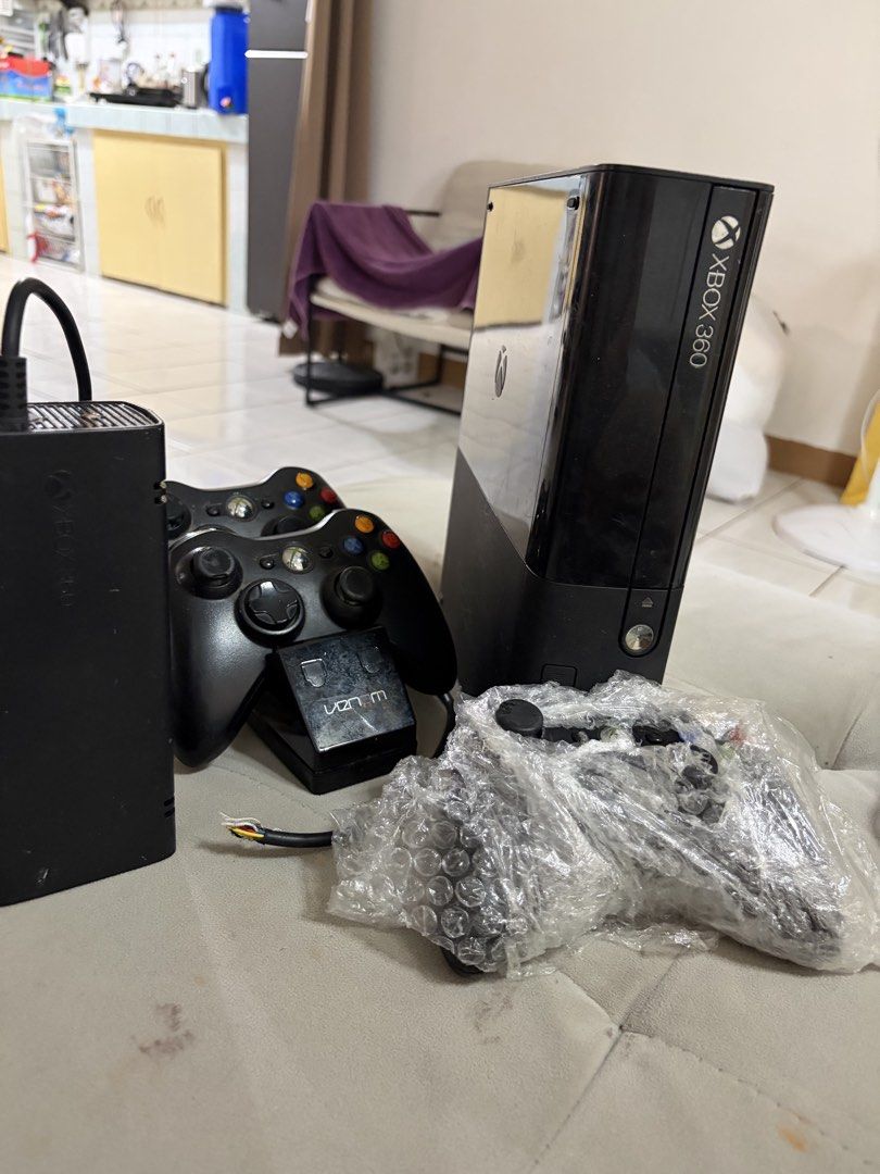 Xbox 360 Slim with 3 Controllers (Category: Xbox) located in Manila. Submitted by jollinamoy05167 (Listing ID 1438775985, Image 2). Description: - Xbox 360 Slim console (black) - Includes three black controllers 1 still new - Power supply included (power cable has exposed wires) - Includes a charging dock.