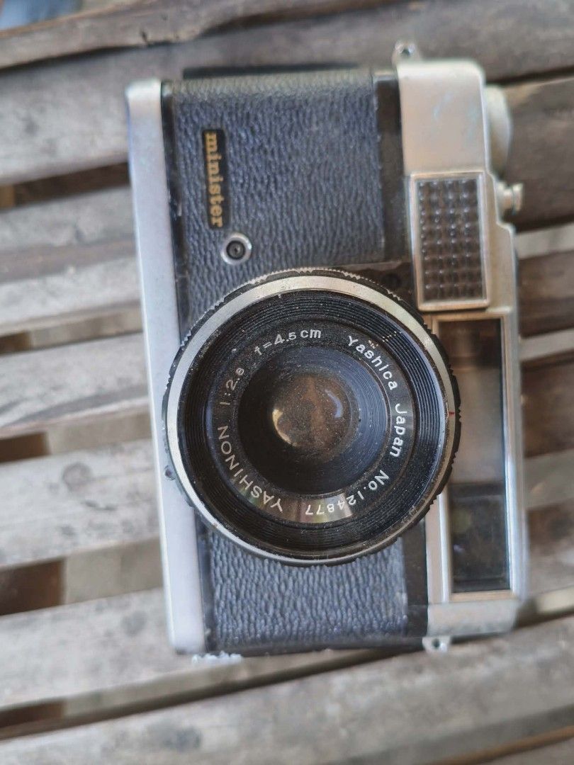 Yashica Minister Camera (Category: Cameras) located in San Fernando. Submitted by kristhriftshop13 (Listing ID 1438713697, Image 1). Description: - Vintage Yashica Minister camera - Yashinon 1:2.8 f=4.5cm lens - Black leatherette body with silver accents - Lens serial number: 129877 - Minister logo on the front.