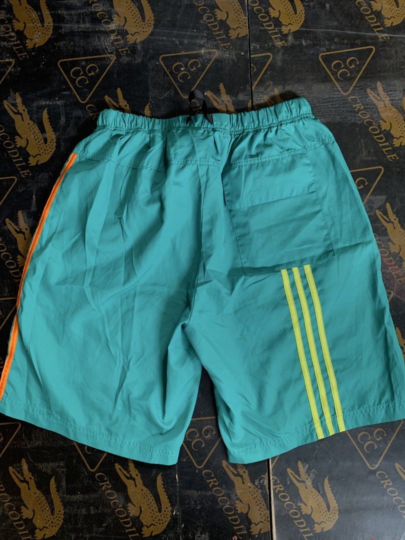 Adidas Shorts XL (Category: Shorts) located in Baguio. Submitted by brix6699 (Listing ID 1435589019, Image 2). Description: - Adidas teal shorts - Orange and yellow stripes - Two black cargo pockets with Adidas logo - Elastic waistband with buckle closure - Size XL fits 34-36 -No issues Dimensions Length 19.5 inches Leg opening 12.5 inches .