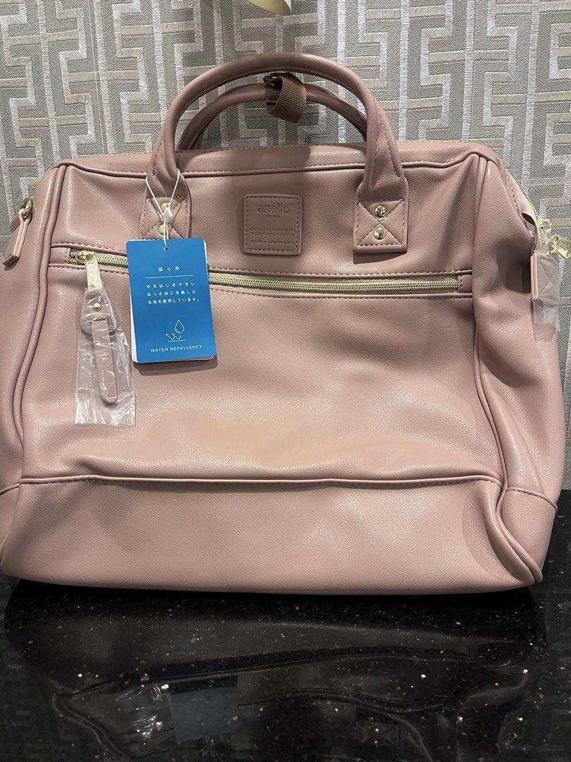 Anello Retro 3-way Bag (Category: Backpacks) located in Pasig City. Submitted by jackiedla (Listing ID 1435656308, Image 1). Description: - Anello handbag in dusty rose - Water-repellent design - Main compartment with zipper closure - Front pocket - Top handles - Detachable shoulder strap - Includes tag indicating water repellency.