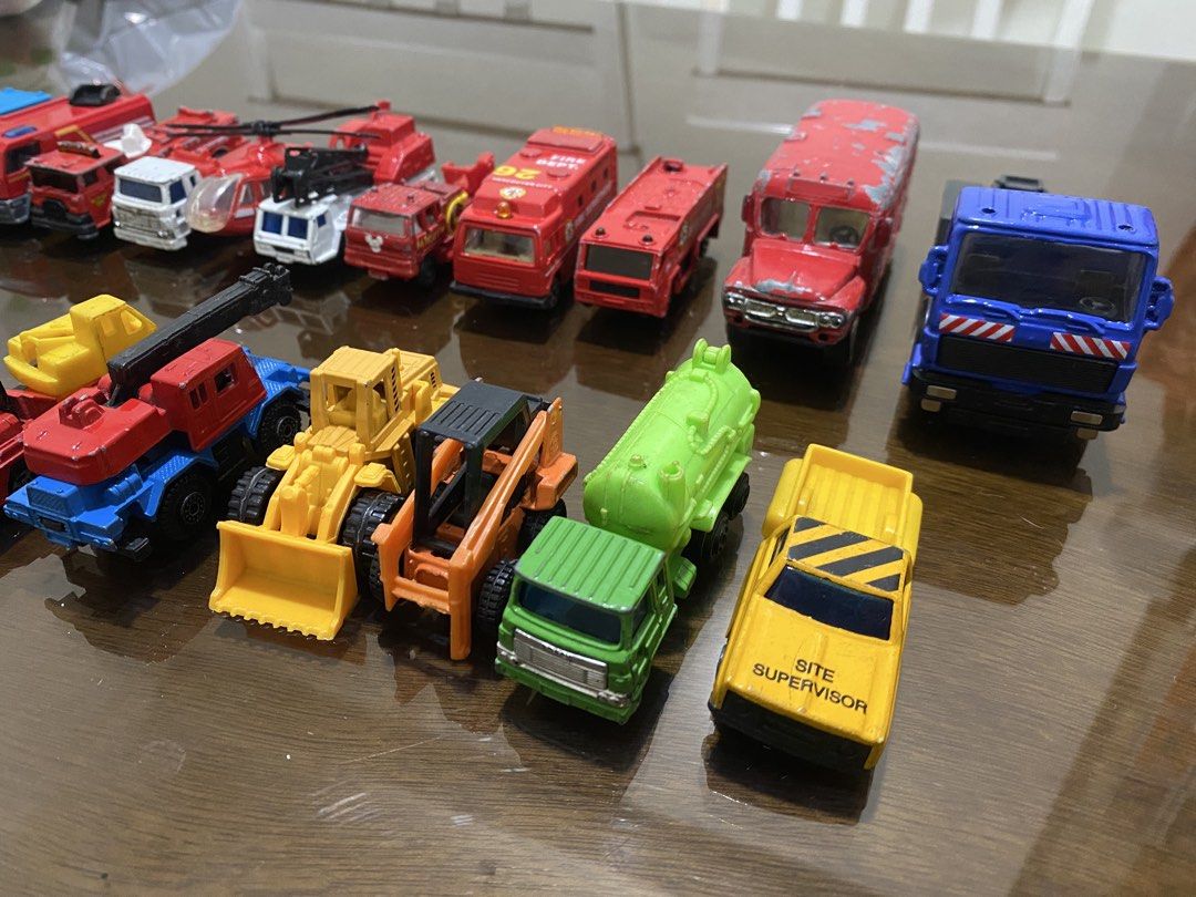 Assorted Diecast Toy Cars (Category: Vehicle & Diecast Models) located in Quezon City. Submitted by declutterthingzzz (Listing ID 1435712907, Image 2). Description: - Variety of diecast toy cars: fire trucks, police cars, construction vehicles, and a helicopter. - Features different colors and designs. - Detailed accessories like ladders and cranes. - Great for collectors and kids. Items are preloved/preowned/secondhand so limit your expectation.