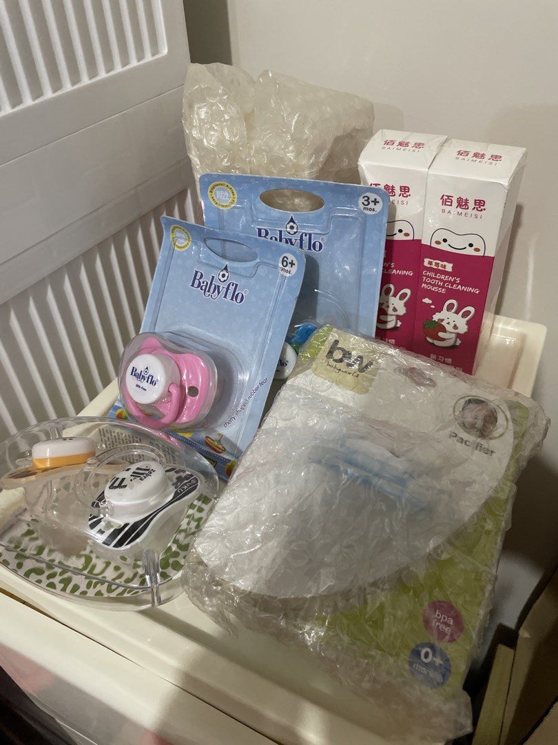 Baby Bundle (6 Toothpastes & 6 Pacifiers) (Category: Baby Toiletries & Grooming) located in Pasay City. Submitted by mamapeihan (Listing ID 1435659826, Image 2). Description: Bundle of pacifiers and tooth cleaning mousse. Includes Baby Flo pacifiers (3+ and 6+ months), Puku pacifiers (zebra and giraffe designs), and Baimeisi Children's Tooth Cleaning Mousse. The pacifiers are in their original packaging. The tooth cleaning mousse is also new..