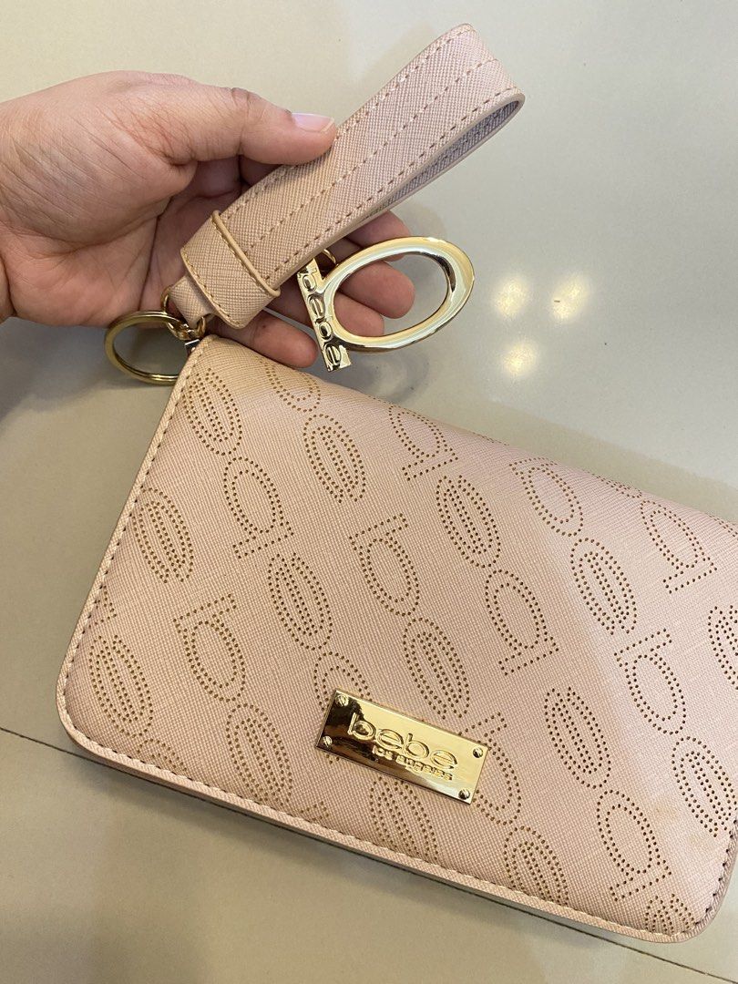 Bebe Los Angeles Wallet with Chain (Category: Cross-body Bags) located in Manila. Submitted by danjim (Listing ID 1435532356, Image 2). Description: - Bebe Los Angeles wallet - Light pink exterior - Gold-tone chain strap - Wristlet strap - Magnetic closure - Interior: Zippered pocket and main compartment - Bebe Los Angeles logo on front.