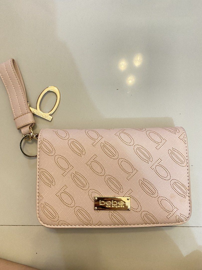 Bebe Los Angeles Wallet with Chain (Category: Cross-body Bags) located in Manila. Submitted by danjim (Listing ID 1435532356, Image 1). Description: - Bebe Los Angeles wallet - Light pink exterior - Gold-tone chain strap - Wristlet strap - Magnetic closure - Interior: Zippered pocket and main compartment - Bebe Los Angeles logo on front.