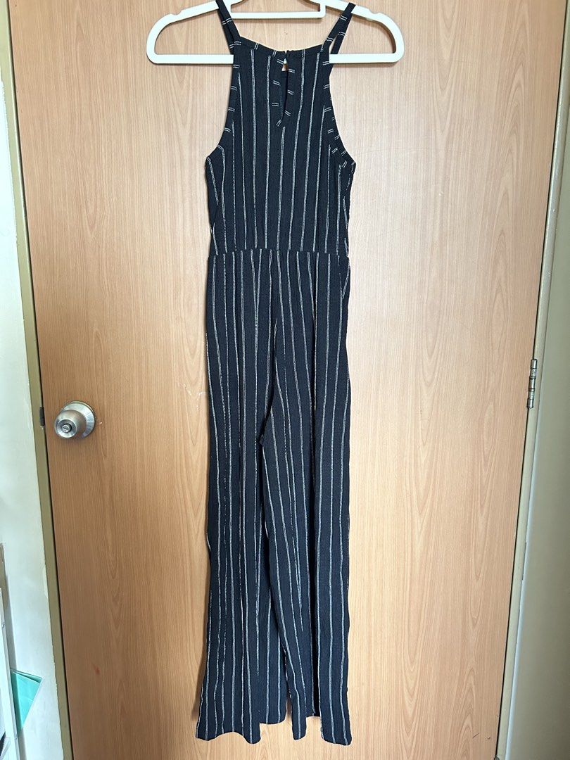 Bershka Striped Jumpsuit - XS (Category: Jumpsuits) located in Paranaque City. Submitted by unleashedcollections (Listing ID 1435590107, Image 2). Description: Bershka jumpsuit in black with white vertical stripes. Features a halter neckline and a fitted waist. With minor flaw (see photo 4). The size is XS. .
