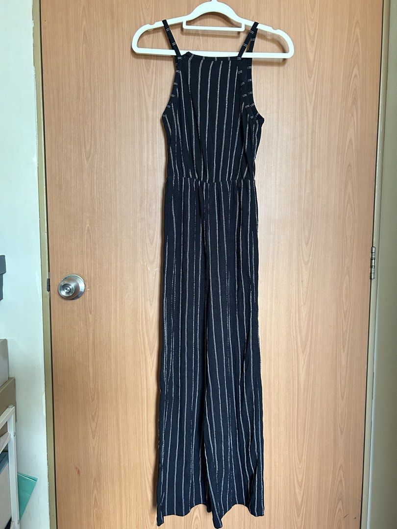 Bershka Striped Jumpsuit - XS (Category: Jumpsuits) located in Paranaque City. Submitted by unleashedcollections (Listing ID 1435590107, Image 3). Description: Bershka jumpsuit in black with white vertical stripes. Features a halter neckline and a fitted waist. With minor flaw (see photo 4). The size is XS. .