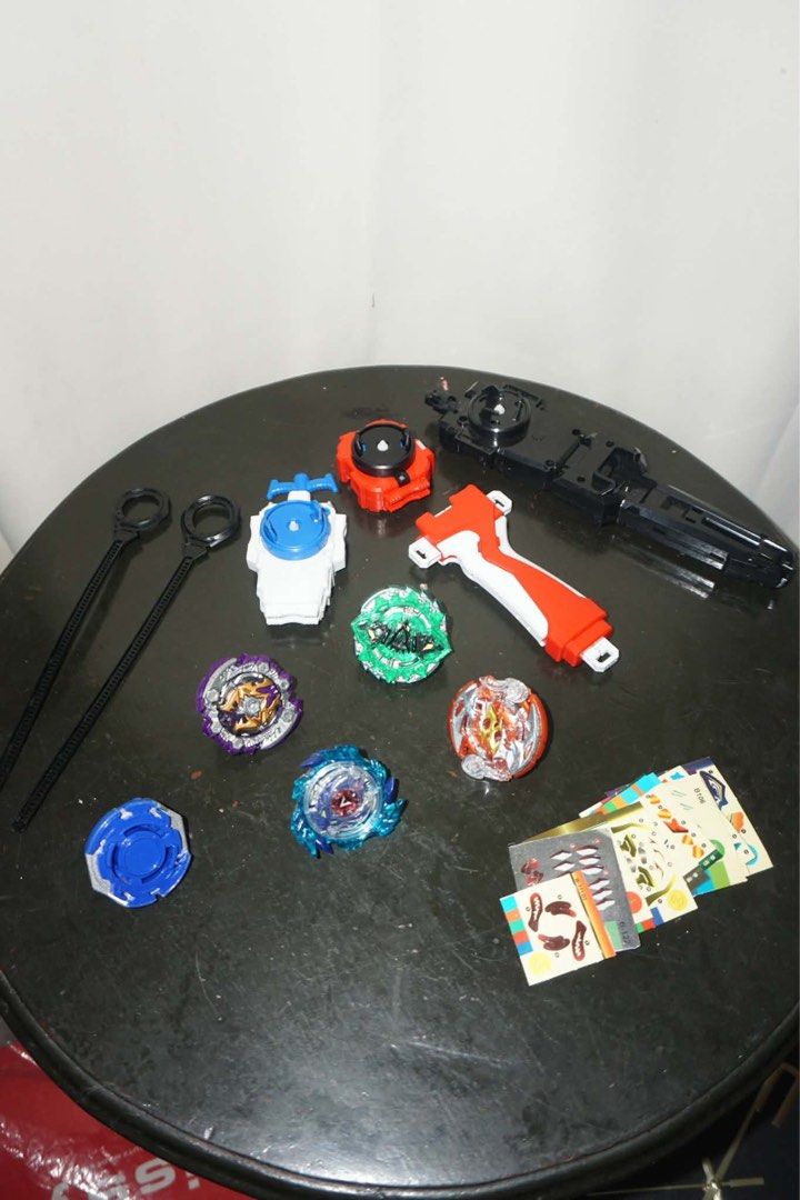 Beyblade Set with Pokemon Cards (Category: Action & Battle Toys) located in Antipolo. Submitted by ttrends (Listing ID 1435635352, Image 1). Description: - Beyblade set with tops, launchers, and accessories. - Includes a variety of Beyblade tops in different colors. - Launchers are also included. - Free bonus: A collection of Pokemon cards and other. - Pokemon cards are a mix of different cards..