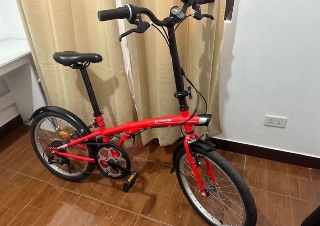 Btwin Foldable Bike - Red (Category: Bicycles) located in Caloocan City. Submitted by eunoshop (Listing ID 1435636246, Image 3). Description: Btwin Foldable Red Bike 📌 Condition: In Good condition 📌Issue: Needs tune in and back wheels is flat. You will be the one to shoulder and responsible to fix that but all in all it is good. No major damage. 📌 Reason for Selling (RFS): Need funds 💰 Price: ₱9,000 🔹 Brand: Btwin 📍 Meetup: Capitol Park Hom