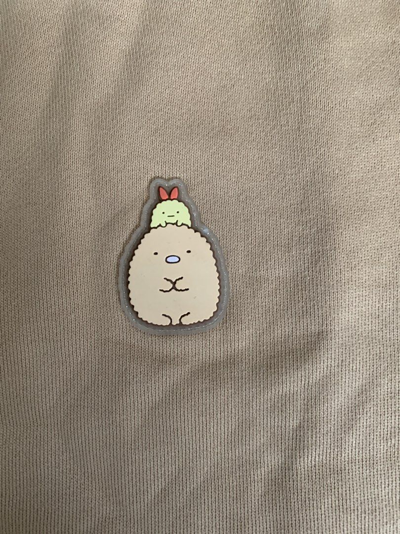 Chocolate Sumikko Gurashi Sweatshirt (Category: Longsleeves) located in Baguio. Submitted by brix6699 (Listing ID 1435608775, Image 2). Description: Tan-colored sweatshirt from Chocolate with Sumikko Gurashi design. Features striped sleeves and a small character patch on the chest. - size is S -No issue -Dimensions Length 25.5 inches Width 22 inches Length of sleeves 21.5 inches.