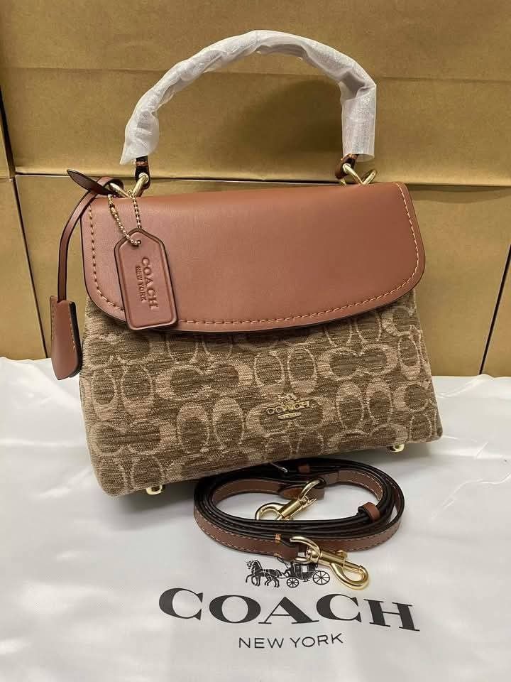 Coach Emory Top Handle bag (Category: Other Accessories) located in Rizal. Submitted by vanbdc24 (Listing ID 1435609614, Image 1). Description: - Authentic Coach handbag - Top handle and detachable strap - Flap closure - Includes Coach tag - Single interior compartment - Small zippered pocket inside - Coach logo on front - Gold-toned hardware.