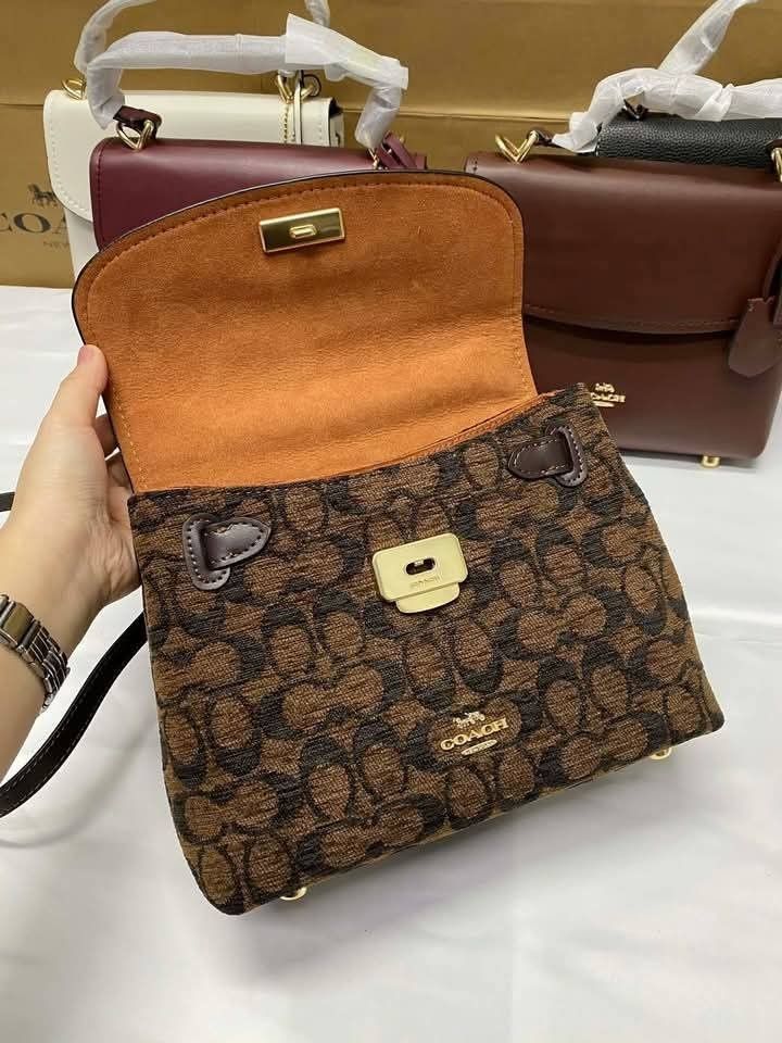 Coach Emory Top Handle bag (Category: Other Accessories) located in Rizal. Submitted by vanbdc24 (Listing ID 1435609614, Image 3). Description: - Authentic Coach handbag - Top handle and detachable strap - Flap closure - Includes Coach tag - Single interior compartment - Small zippered pocket inside - Coach logo on front - Gold-toned hardware.