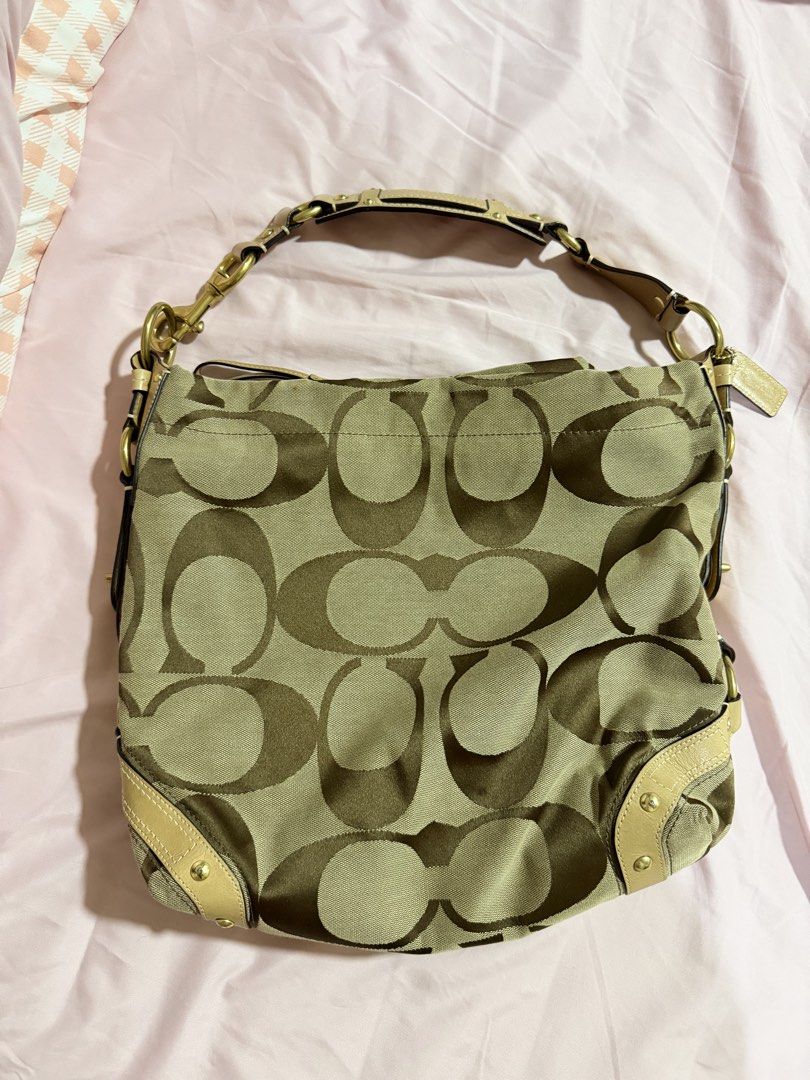 Coach Signature Hobo Bag (Category: Luxury Bags & Wallets) located in Taytay. Submitted by maikymaiks (Listing ID 1435646747, Image 1). Description: - Authentic Vintage Coach Signature Hobo bag - Bought in Japan - Classic Coach pattern in tan and brown - Includes leather tag with Coach logo - Shoulder strap - Turn-lock closure - Purple interior lining Issue: has lipstick stains, not really visible.