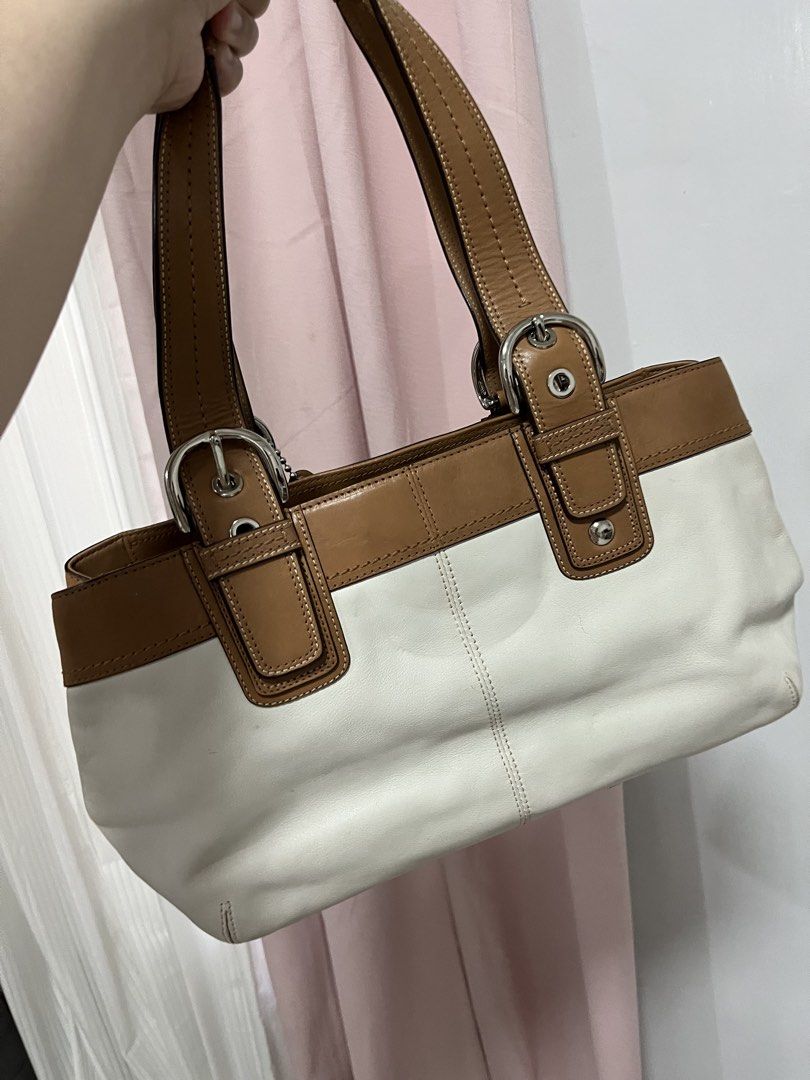 Coach White and Brown Leather Handbag (Category: Luxury Bags & Wallets) located in Malabon City. Submitted by kristine0697 (Listing ID 1435574555, Image 3). Description: - Authentic Coach handbag - White and brown leather exterior - Dual top handles - Silver-tone hardware - Interior includes Coach leather tag with style number NB1075-F13732 - Zip closure - Spacious interior - Classic design - Suitable for everyday use.