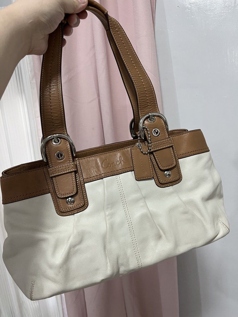 Coach White and Brown Leather Handbag (Category: Luxury Bags & Wallets) located in Malabon City. Submitted by kristine0697 (Listing ID 1435574555, Image 1). Description: - Authentic Coach handbag - White and brown leather exterior - Dual top handles - Silver-tone hardware - Interior includes Coach leather tag with style number NB1075-F13732 - Zip closure - Spacious interior - Classic design - Suitable for everyday use.