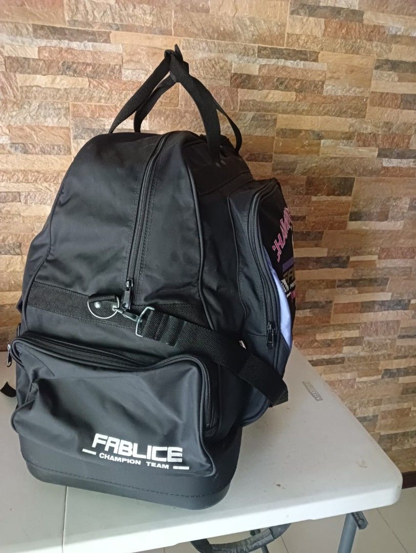 Fablice Champion Team XL Travel Bag (Category: Backpacks) located in Taguig. Submitted by jaybrandedstore (Listing ID 1435527774, Image 3). Description: - Black Four way travel bag -Sling, backpack, handbag and trolley - Features the Fabrice Champion Team logo - Multiple compartments for storage - Includes a shoulder strap for easy carrying - Top handle for convenient handling - Side pocket for extra storage - With Shoes compartment under with wh