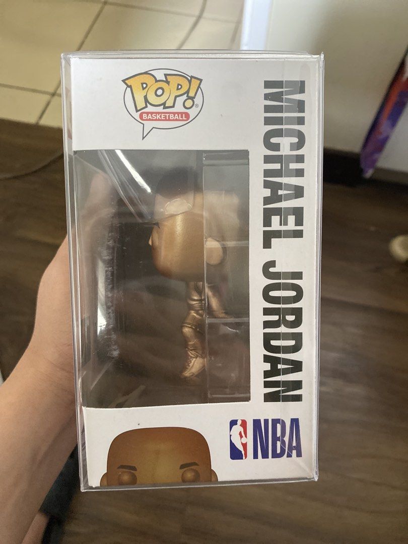 Funko Pop! Basketball Michael Jordan #54 (Category: Designer & Blind Box Toys) located in Quezon City. Submitted by markgatestv (Listing ID 1435542718, Image 2). Description: For sale For Micheal Jordan Collectors 10/10 fresh Almost Brandnew - Michael Jordan Funko Pop! figure - Gold-colored figure - NBA Basketball Series #54 - Features Michael Jordan in his Chicago Bulls uniform - In original packaging - Box includes NBA and Funko Pop! logos - Bo
