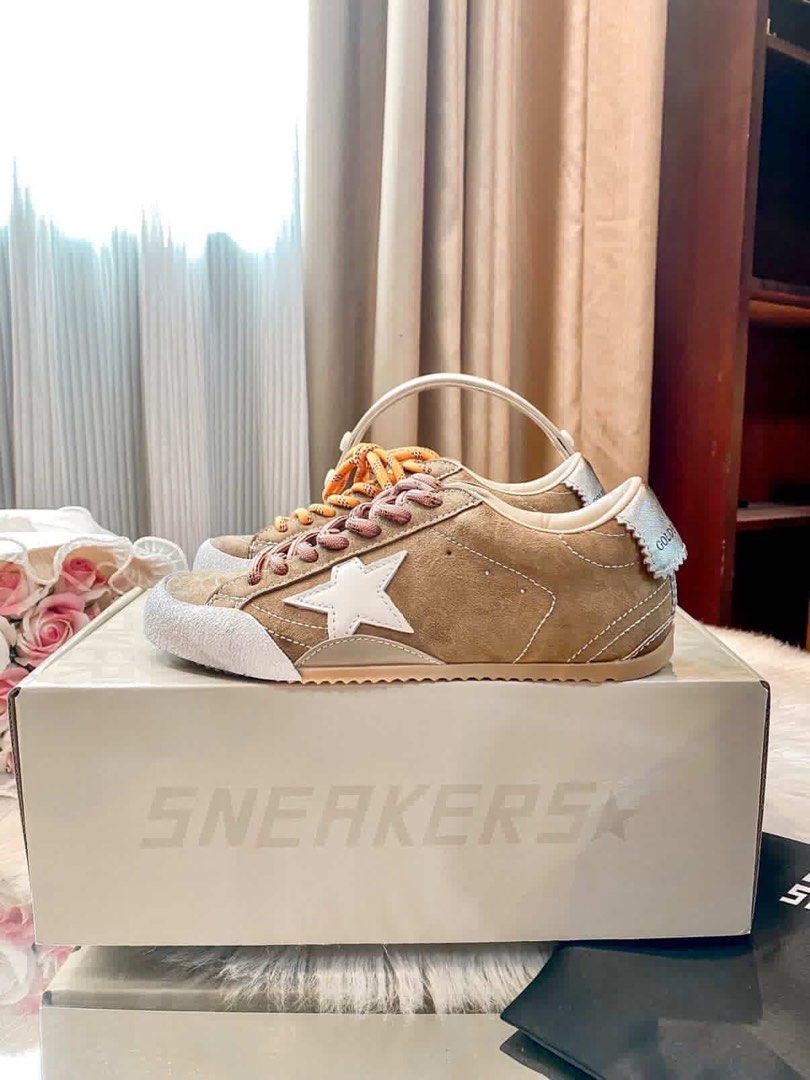 Golden Goose Sneakers (Category: Sneakers) located in Manila. Submitted by cjcj_ (Listing ID 1435625777, Image 1). Description: - Golden Goose sneakers - Brown suede - White star logo - White toe cap - Comes with orange and pink laces - Original box included - Minimal sole wear.
