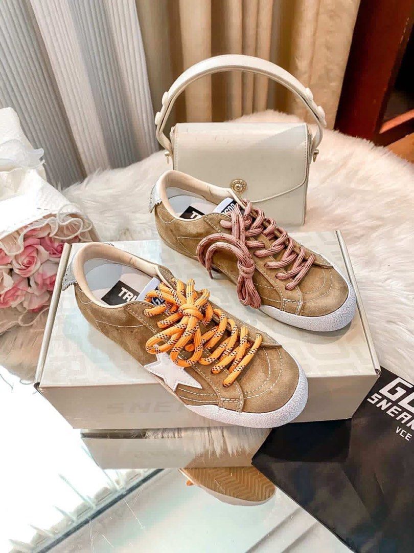 Golden Goose Sneakers (Category: Sneakers) located in Manila. Submitted by cjcj_ (Listing ID 1435625777, Image 2). Description: - Golden Goose sneakers - Brown suede - White star logo - White toe cap - Comes with orange and pink laces - Original box included - Minimal sole wear.