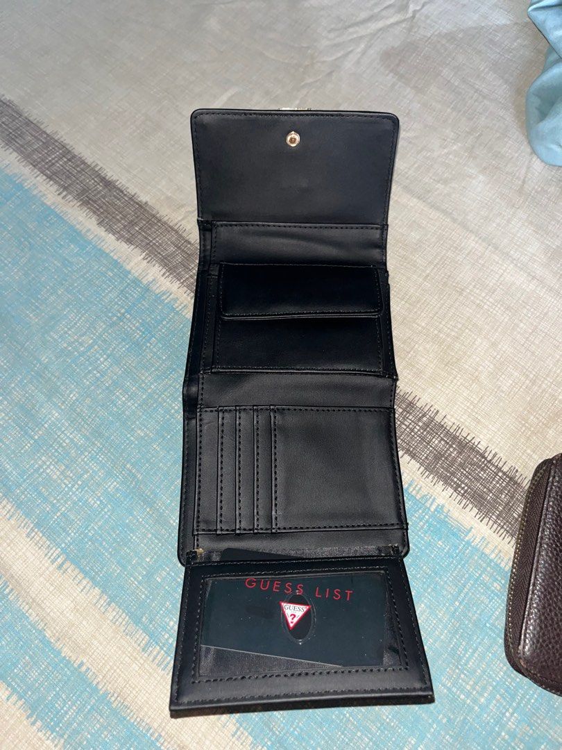 GUESS Black Trifold Wallet (Category: Wallets & Card holders) located in Dumaguete. Submitted by ems_decluttering (Listing ID 1435653289, Image 3). Description: Selling this authentic GUESS black trifold wallet. Barely used and kept in excellent condition, looks almost brand new since it was just bought 3 weeks ago. Price still negotiable! Details: Color: Black Material: Textured leather (saffiano-style finish) Closure: Snap button with metal GUE