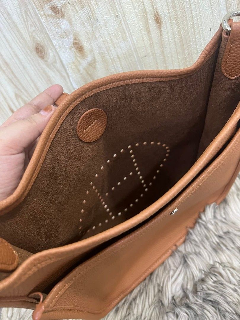 Hermes Evelyne III Shoulder Bag (Category: Luxury Bags & Wallets) located in Davao. Submitted by navil01 (Listing ID 1435591539, Image 3). Description: - Brown shoulder bag - Perforated Hermes logo - Adjustable long strap - Flap closure - Matching brown interior lining - Top handle - Back pocket - Silver-toned hardware.