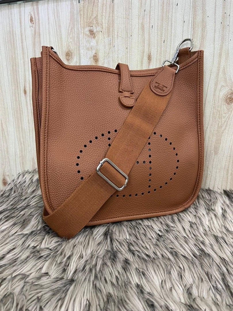 Hermes Evelyne III Shoulder Bag (Category: Luxury Bags & Wallets) located in Davao. Submitted by navil01 (Listing ID 1435591539, Image 1). Description: - Brown shoulder bag - Perforated Hermes logo - Adjustable long strap - Flap closure - Matching brown interior lining - Top handle - Back pocket - Silver-toned hardware.
