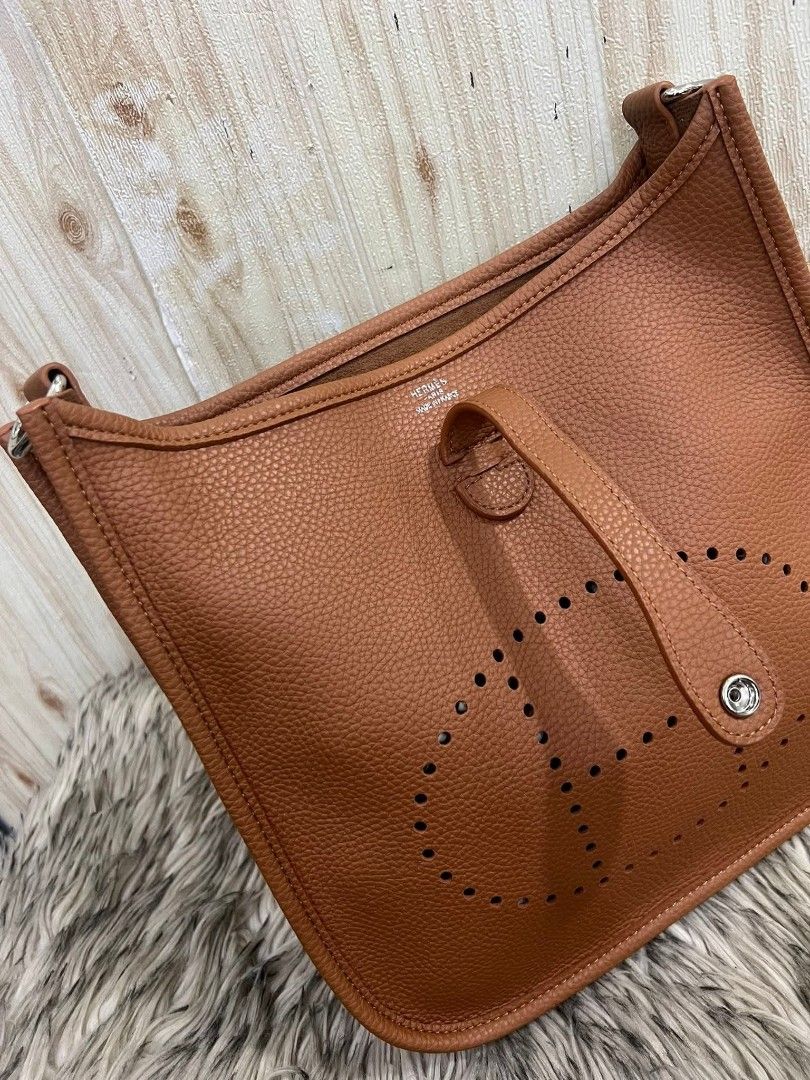 Hermes Evelyne III Shoulder Bag (Category: Luxury Bags & Wallets) located in Davao. Submitted by navil01 (Listing ID 1435591539, Image 2). Description: - Brown shoulder bag - Perforated Hermes logo - Adjustable long strap - Flap closure - Matching brown interior lining - Top handle - Back pocket - Silver-toned hardware.