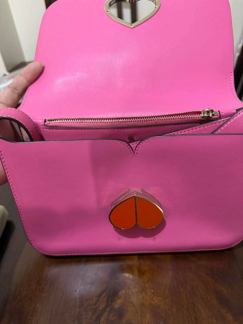 Kate Spade Pink Shoulder Bag (Category: Luxury Bags & Wallets) located in Mandaluyong City. Submitted by joooliiieee (Listing ID 1435623317, Image 2). Description: - Authentic Kate Spade shoulder bag - Eye-catching pink color - Spade-shaped clasp with orange center - Interior zippered pocket - Crafted from leather.