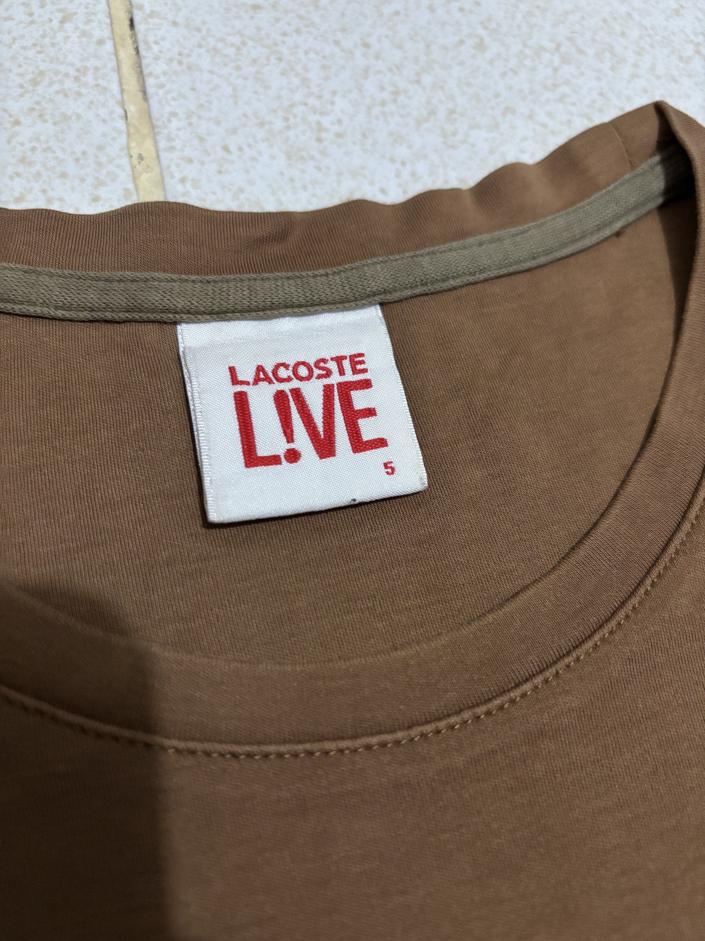 Lacoste Live Brown T-Shirt (Category: Tshirts & Polo Shirts ) located in Manila. Submitted by kenriegab (Listing ID 1435612825, Image 3). Description: - Lacoste Live T-shirt - Size 5 - Classic Lacoste logo on the chest - Comfortable crew neck - Short sleeves - Made from 100% cotton - Perfect for everyday wear Dimes: L 26.5 x W 19.5 Color rate: 9 / 10 Excellent condition +shipping fee.
