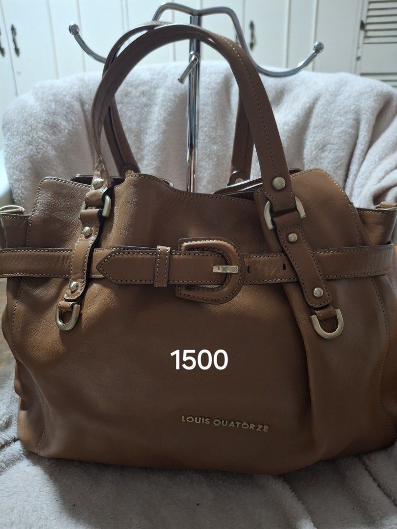 Louis Quatorze Brown Leather Handbag (Category: Luxury Bags & Wallets) located in Pasig City. Submitted by elanisonwhat (Listing ID 1435612233, Image 1). Description: - Louis Quatorze brown leather handbag - Buckle closure - Double handles - Spacious interior - Classic design - Stylish for everyday use DM for inquiries Negotiable.