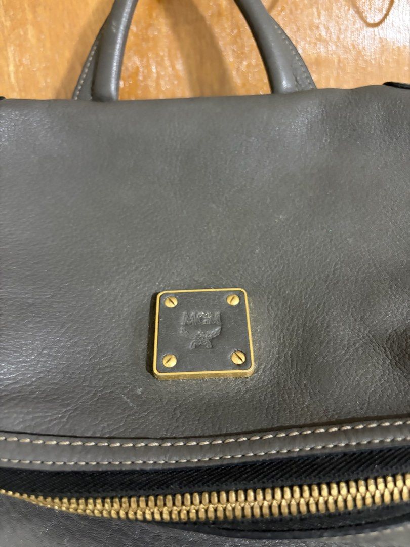 sale/trade: MCM Gray Leather Backpack (Category: Luxury Bags & Wallets) located in Cavite. Submitted by jcvee (Listing ID 1435581248, Image 2). Description: - Authentic MCM backpack - Gray leather exterior - Multiple zippered compartments - Top handle - Adjustable shoulder straps - Fabric lining - Gold-tone hardware - MCM logo on front and inside.