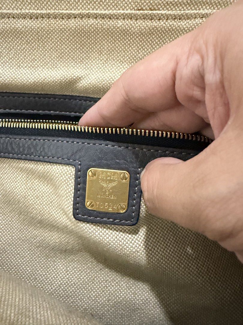 sale/trade: MCM Gray Leather Backpack (Category: Luxury Bags & Wallets) located in Cavite. Submitted by jcvee (Listing ID 1435581248, Image 3). Description: - Authentic MCM backpack - Gray leather exterior - Multiple zippered compartments - Top handle - Adjustable shoulder straps - Fabric lining - Gold-tone hardware - MCM logo on front and inside.