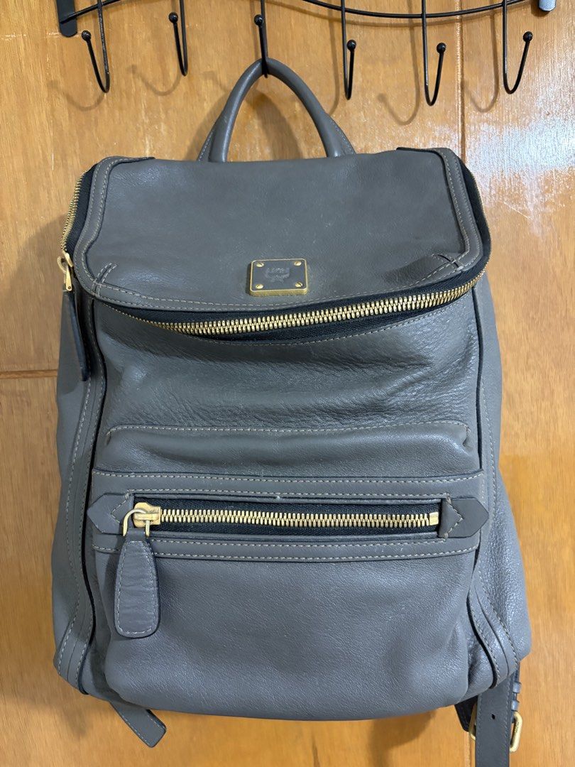 sale/trade: MCM Gray Leather Backpack (Category: Luxury Bags & Wallets) located in Cavite. Submitted by jcvee (Listing ID 1435581248, Image 1). Description: - Authentic MCM backpack - Gray leather exterior - Multiple zippered compartments - Top handle - Adjustable shoulder straps - Fabric lining - Gold-tone hardware - MCM logo on front and inside.