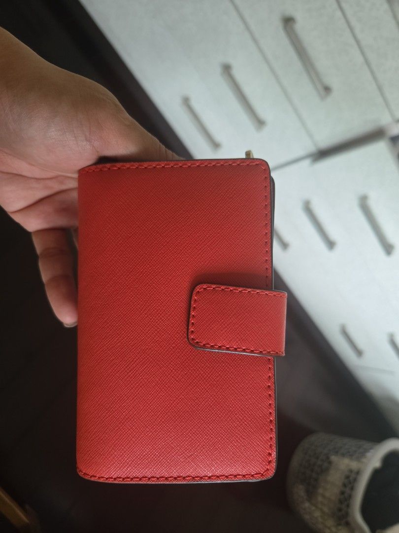 Michael Kors Jet Set Travel Wallet (Category: Luxury Bags & Wallets) located in Taguig. Submitted by shoptiludrop888 (Listing ID 1435630370, Image 2). Description: - Authentic Michael Kors Jet Set Travel wallet - new with tags. - Vibrant red color - Zip-around closure - Multiple compartments for cards and cash - Includes original tags and care cards - Compact and stylish design - Light-colored interior lining with Michael Kors logo.