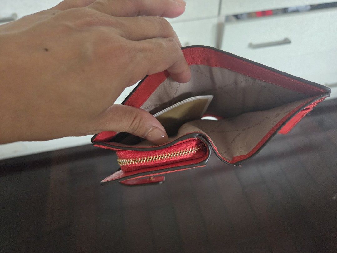 Michael Kors Jet Set Travel Wallet (Category: Luxury Bags & Wallets) located in Taguig. Submitted by shoptiludrop888 (Listing ID 1435630370, Image 3). Description: - Authentic Michael Kors Jet Set Travel wallet - new with tags. - Vibrant red color - Zip-around closure - Multiple compartments for cards and cash - Includes original tags and care cards - Compact and stylish design - Light-colored interior lining with Michael Kors logo.