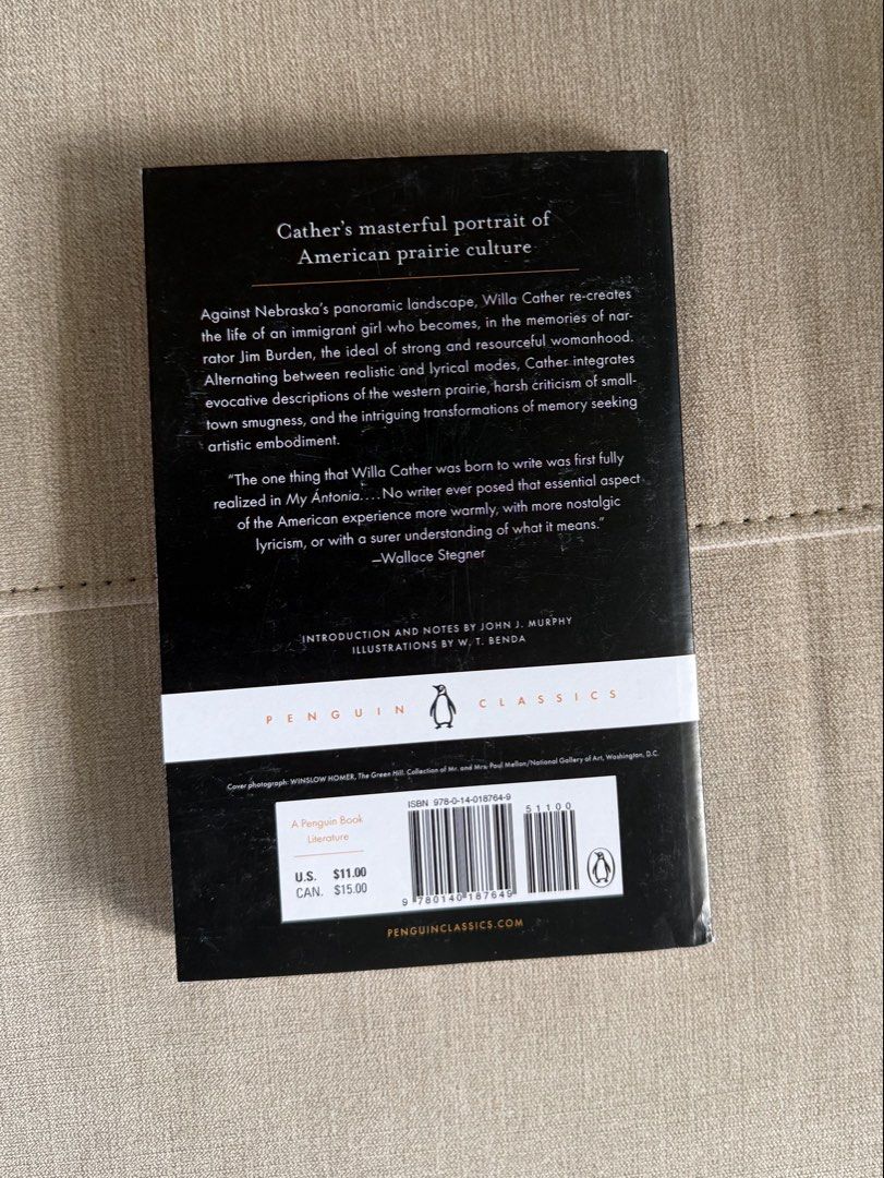 My Antonia - Willa Cather (Penguin Classics ) (Category: Storybooks) located in Davao. Submitted by friesflakes (Listing ID 1435524998, Image 2). Description: - "My Antonia" by Willa Cather - Penguin Classics edition - Cover illustration of a woman in a field - Includes story summary on the back - Features a quote by Wallace Stegner - White spine with Penguin Classics logo.