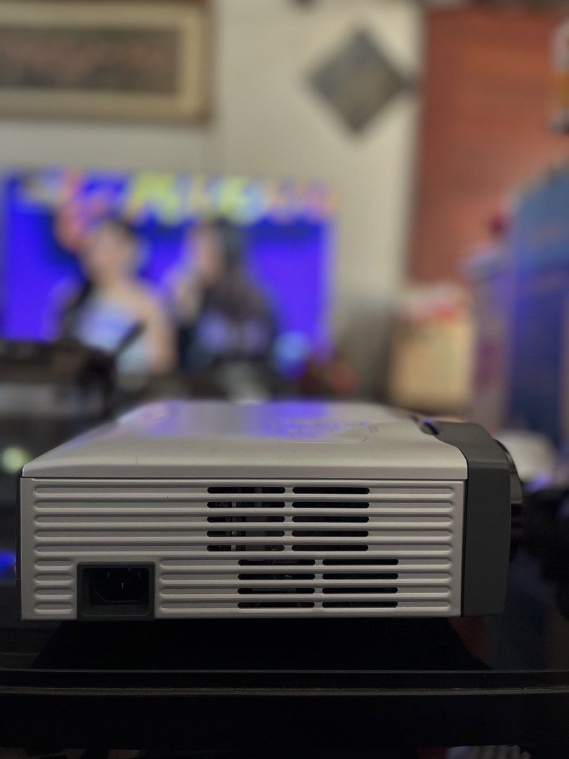 Optoma EP739 Projector (Category: Projectors) located in Obando. Submitted by approachable_mom08 (Listing ID 1435676415, Image 3). Description: - Optoma EP739 projector - Multiple input ports: VGA, audio, DVI - Zoom and focus controls - DLP technology - Silver and gray color scheme - Serial number and model information on the bottom.