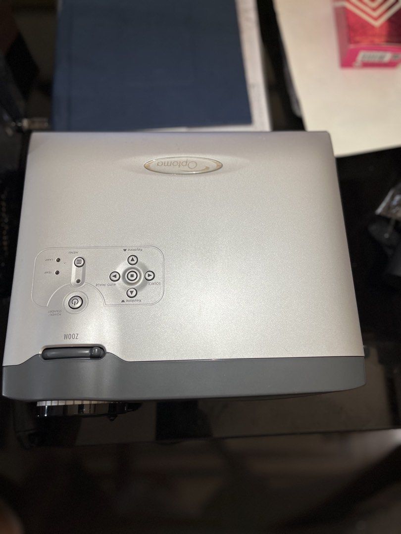 Optoma EP739 Projector (Category: Projectors) located in Obando. Submitted by approachable_mom08 (Listing ID 1435676415, Image 2). Description: - Optoma EP739 projector - Multiple input ports: VGA, audio, DVI - Zoom and focus controls - DLP technology - Silver and gray color scheme - Serial number and model information on the bottom.