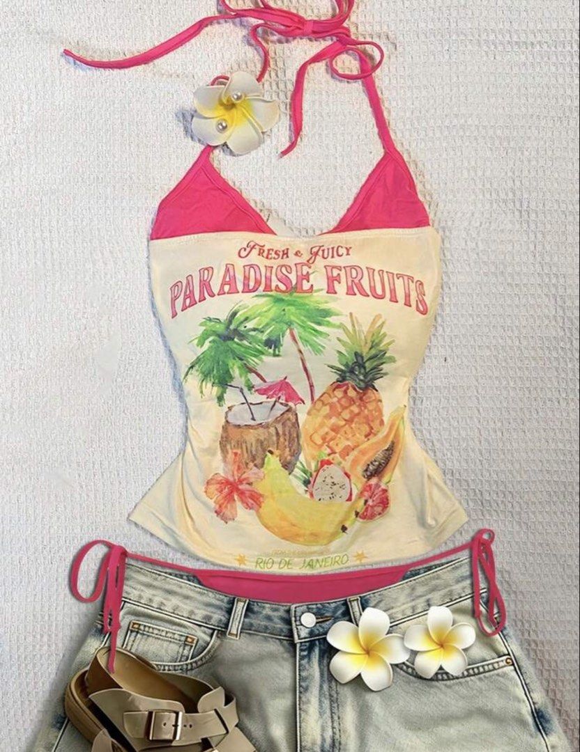 Paradise Fruits Tank Top (Category: Sleeveless) located in San Antonio. Submitted by lalisachu (Listing ID 1435525179, Image 2). Description: - Tank top with a fun "Paradise Fruits" print. - Design: Halter neck with a stylish pink trim. - Perfect for summer! - Great for pairing with denim shorts (as shown)..