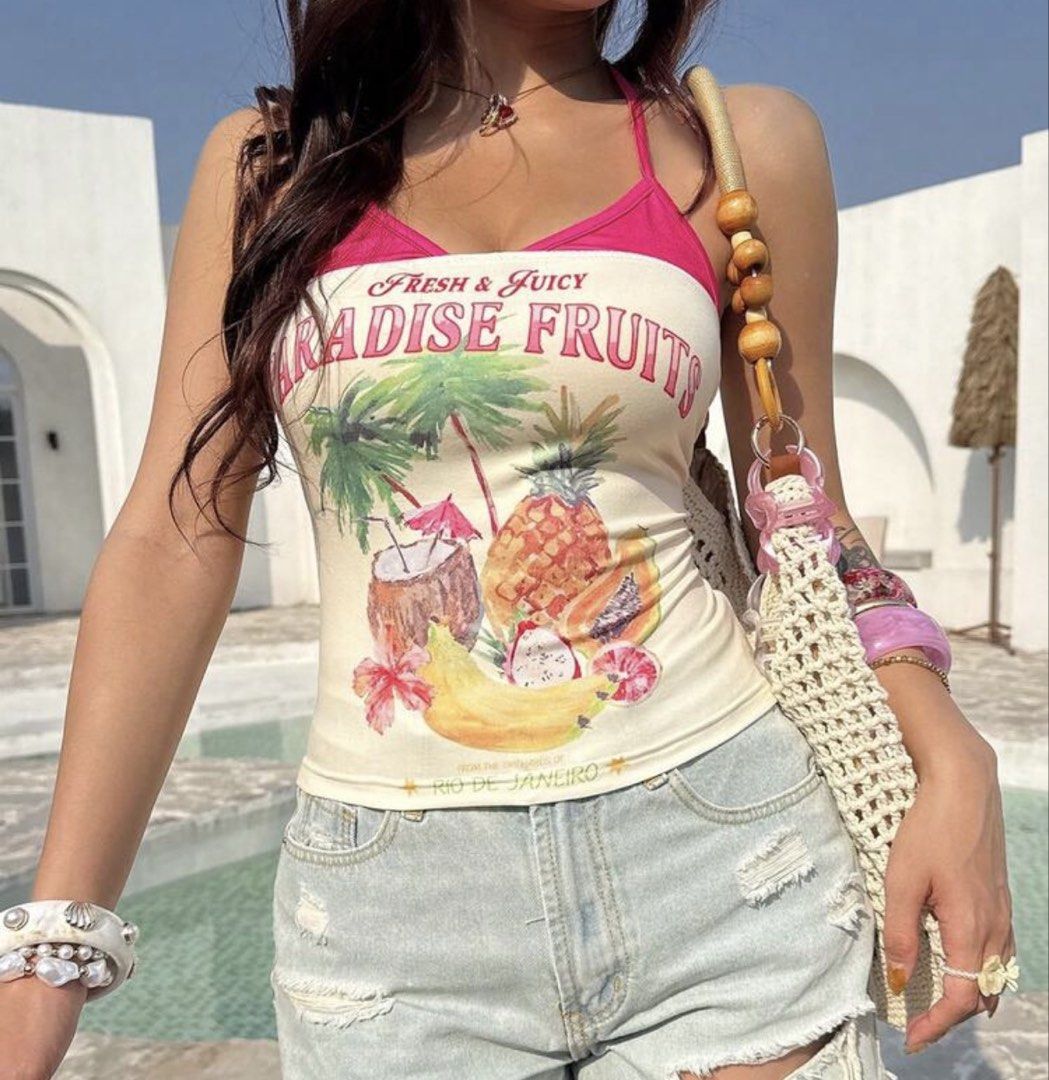 Paradise Fruits Tank Top (Category: Sleeveless) located in San Antonio. Submitted by lalisachu (Listing ID 1435525179, Image 1). Description: - Tank top with a fun "Paradise Fruits" print. - Design: Halter neck with a stylish pink trim. - Perfect for summer! - Great for pairing with denim shorts (as shown)..