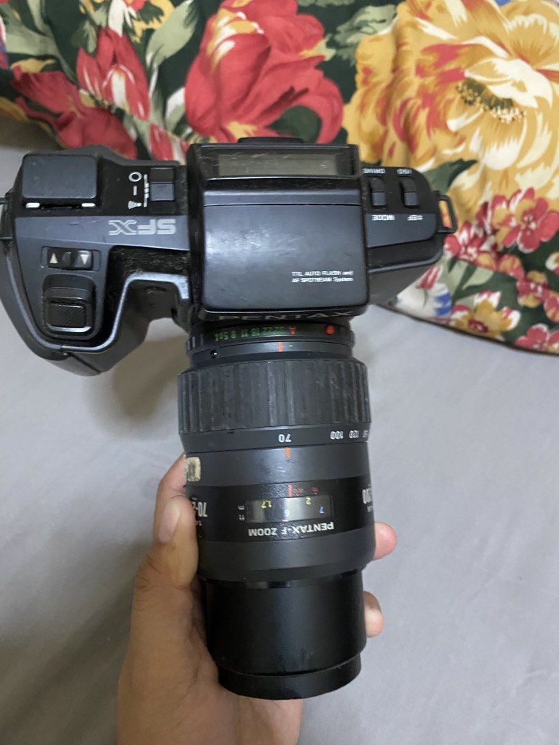 Pentax SFX Camera with Lens (Category: Cameras) located in Baguio. Submitted by karent3000 (Listing ID 1435627228, Image 2). Description: Pentax SFX camera with a 70-200mm lens. Includes a Pentax Data Back F. The camera body is black. The lens has zoom capabilities. The camera has a built-in flash. The camera has a mode select and adjust button. The camera has a viewfinder. Untested. Selling as is. Kayo na po pa test. .