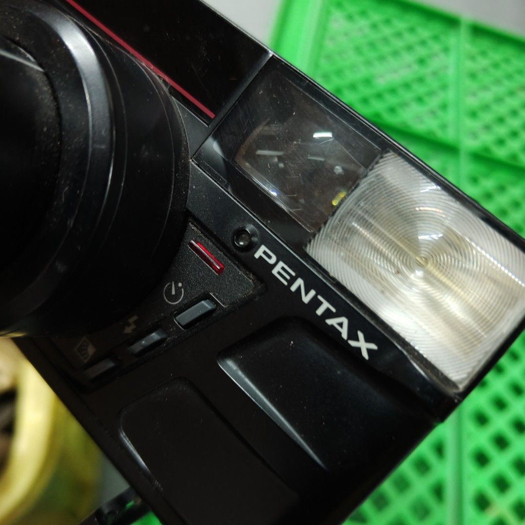 Pentax Zoom 70 Film Camera (Category: Cameras) located in Manila. Submitted by rossinicalabig (Listing ID 1435588606, Image 3). Description: 400 Pesos Only. UNTESTED WITH BATT & FILM. CONDITION: JUNK / FOR PARTS OUT/ EXPERIMENT. Pentax Zoom 70 film camera with a 35-70 zoom lens. Features a built-in flash and various control buttons. The camera has a lens with macro capabilities. The price tag shows 400. Requires four AAA batteries to operate. Che