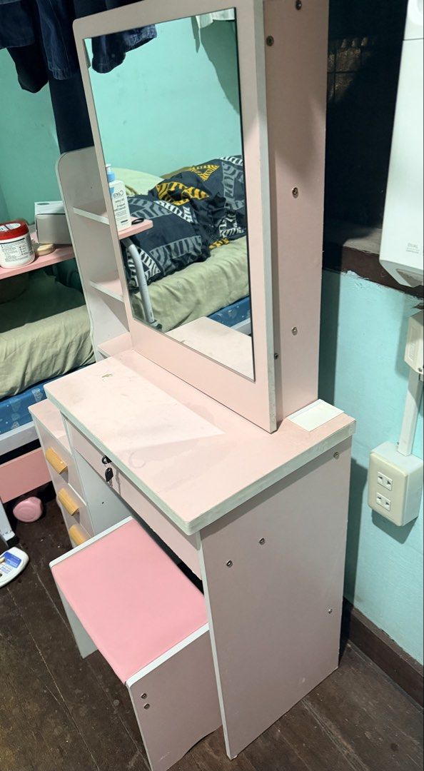 Pink Vanity Table with Mirror and Stool - Assembled (Category: Tables & Sets) located in Quezon City. Submitted by velleshop (Listing ID 1431587609, Image 3). Description: Already Assembled! - Pink vanity table with mirror - Includes matching stool with pink cushioned seat - Features multiple drawers with wooden handles - One drawer with key lock for security - Built-in side shelf unit - Mirror framed in pink.